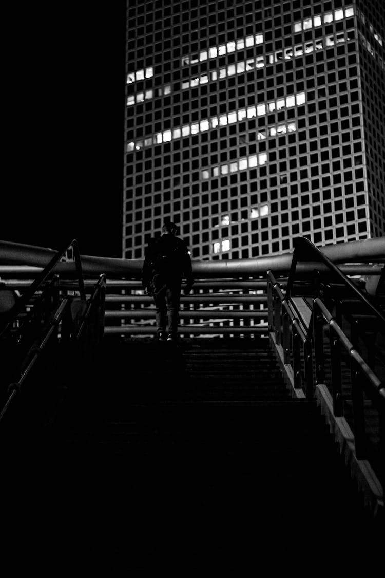 Silhouette Of Person Walking On The Stairs