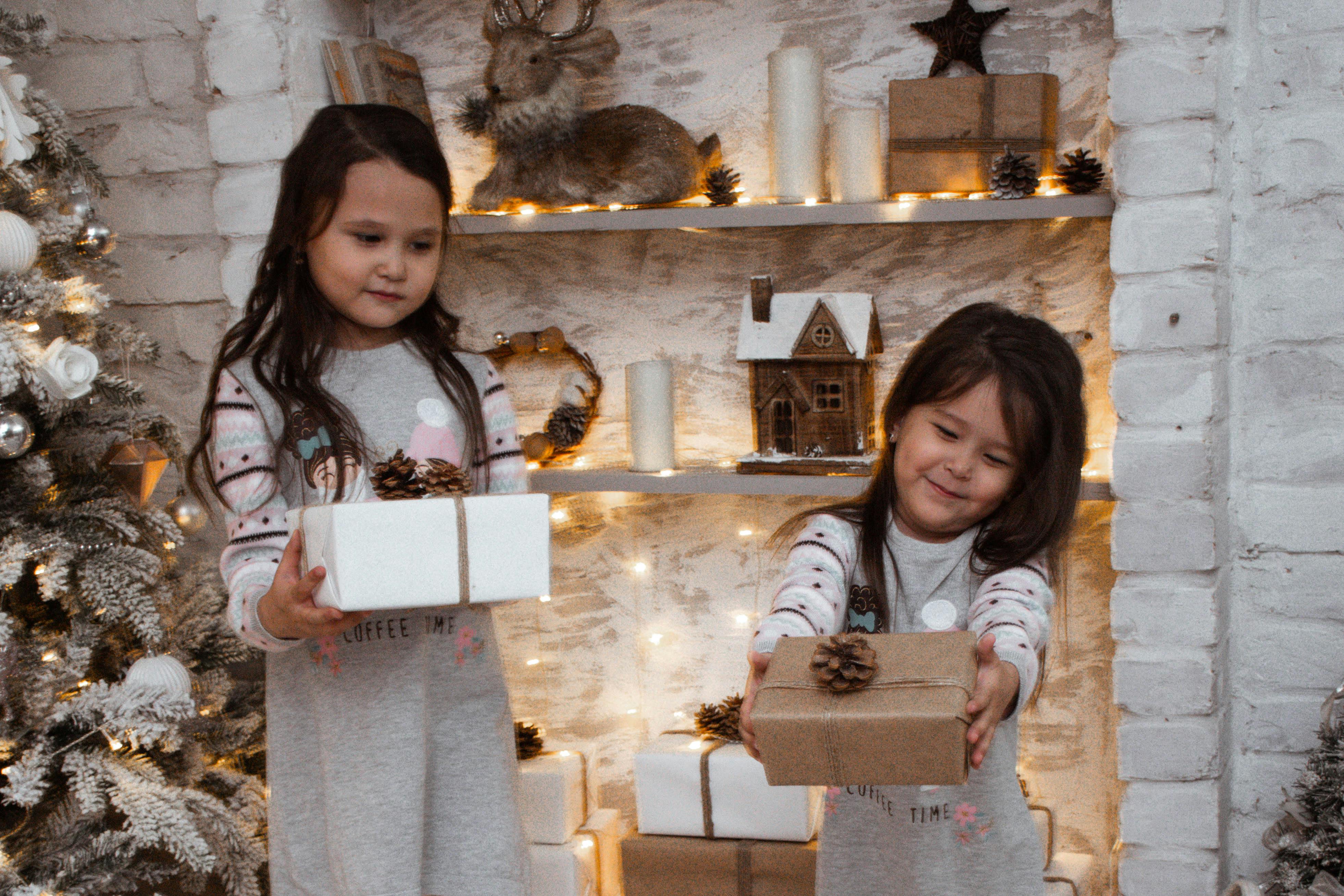 A person holding a smartphone displaying a digital wallet with cryptocurrency balances.