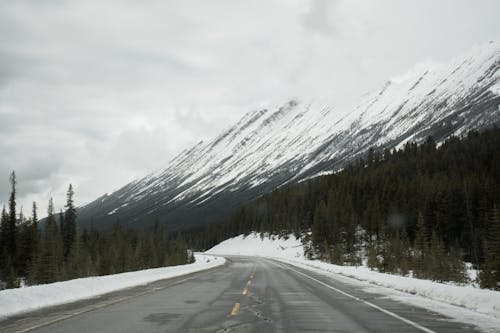Asphalt Road Near Snow Covered Mountain