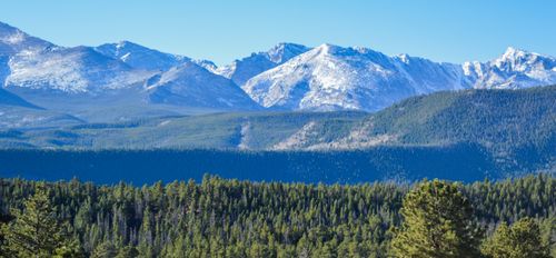 Free Scenic view of snow-capped mountains and forest in Larimer County, Colorado. Stock Photo