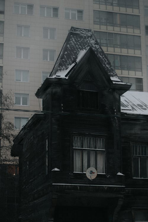 Black Wooden House With Snow on Roof