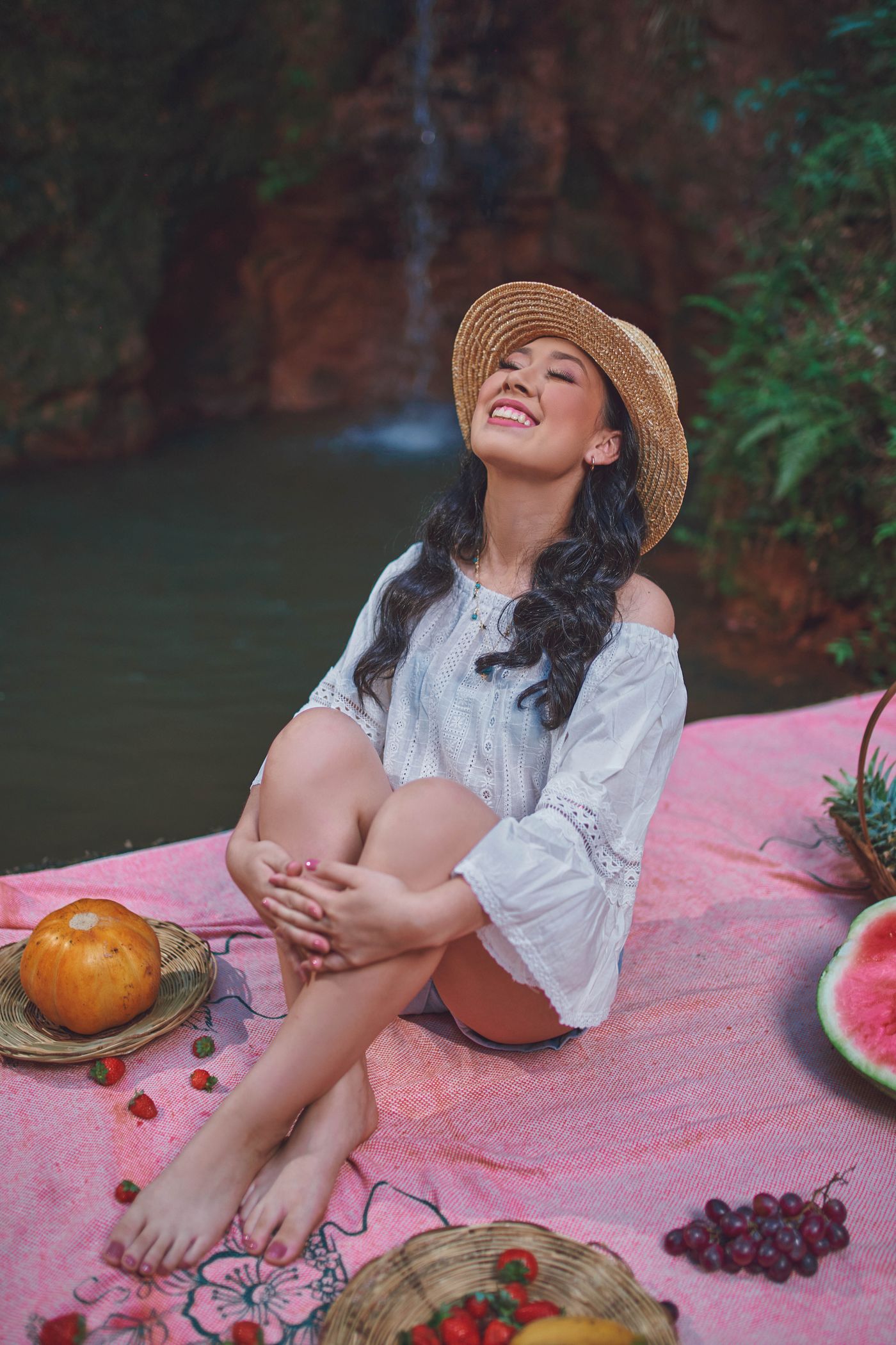 Smiling woman in a straw sun hat outdoors