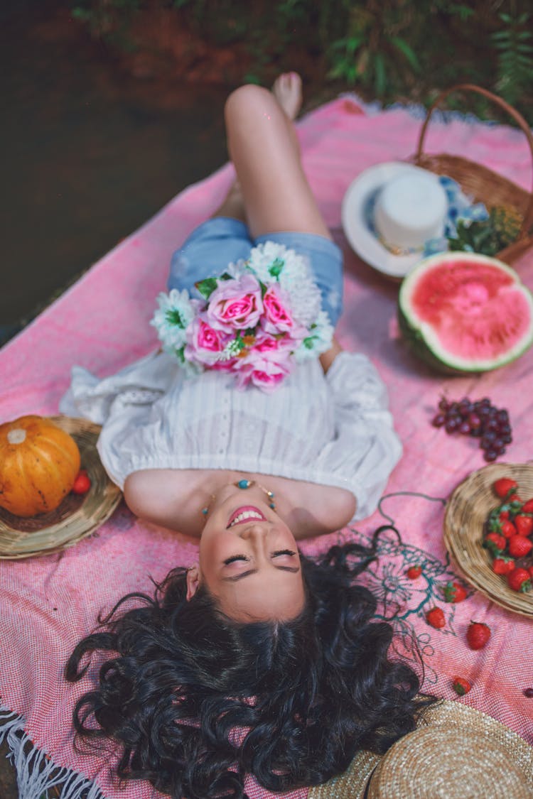 Woman Lying Down On Picnic Blanket