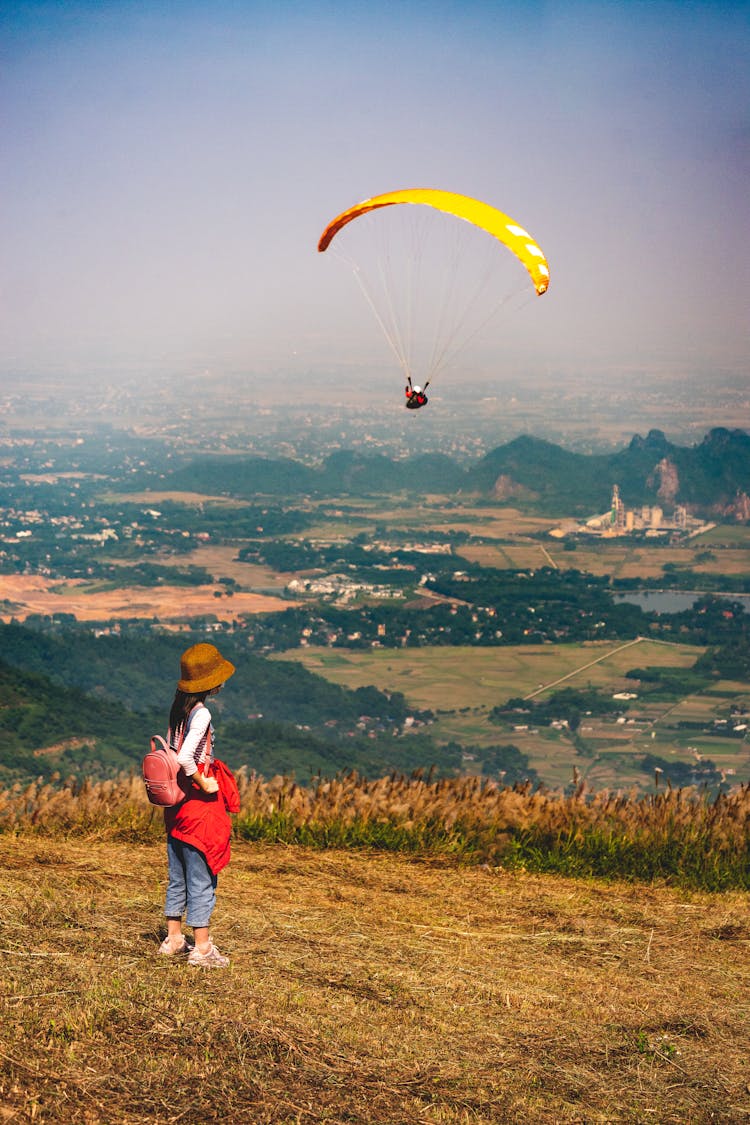 Woman Watching Somebody Paragliding 