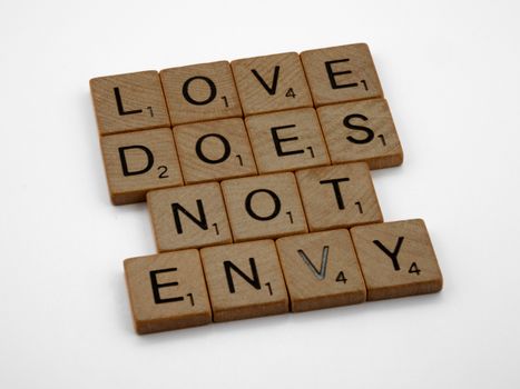 Close-Up Shot of Scrabble Tiles on a White Surface