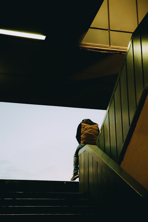 Free Man Sitting in a Staircase Stock Photo