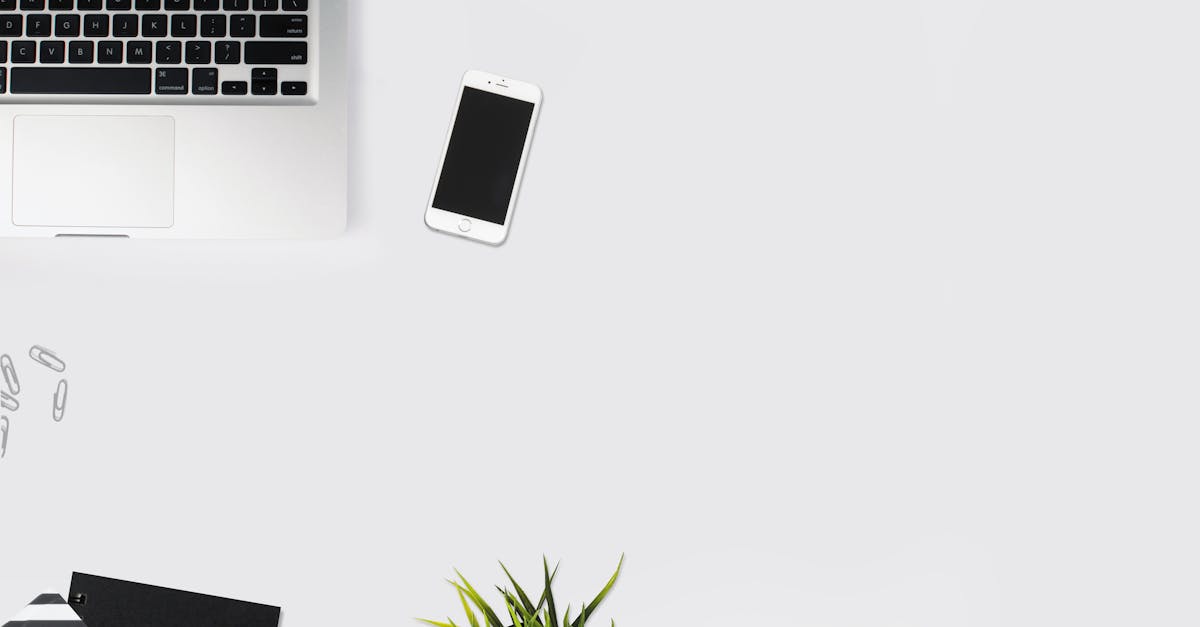 White Smartphone Beside Silver Laptop Computer