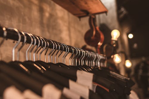 Free Photo of Black Clothes on Hangers Stock Photo