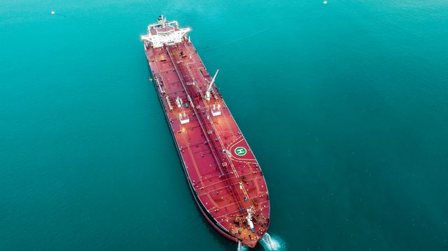 Aerial shot of an oil tanker cruising through the ocean