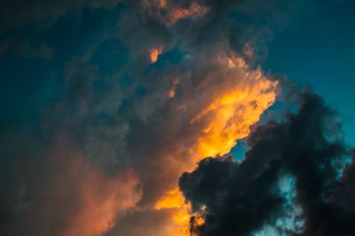 Free Fiery sunset with vivid clouds creating a dynamic evening sky. Stock Photo