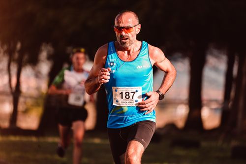 Free Focused male athlete running a marathon outdoors with determination. Stock Photo
