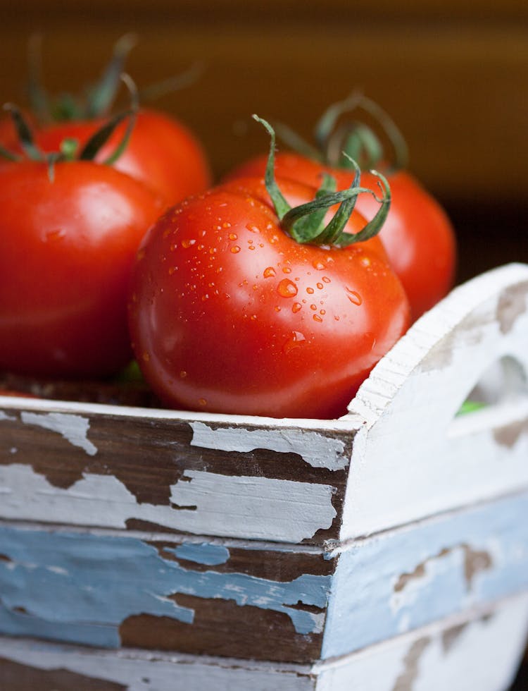 Close-Up Shot Of Tomatoes On A Wooden Crate