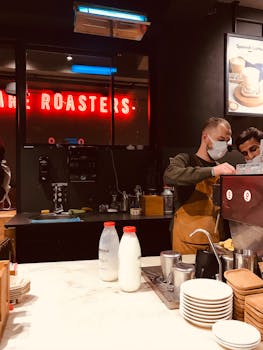 Baristas wearing masks preparing coffee in a trendy İstanbul café during the pandemic.