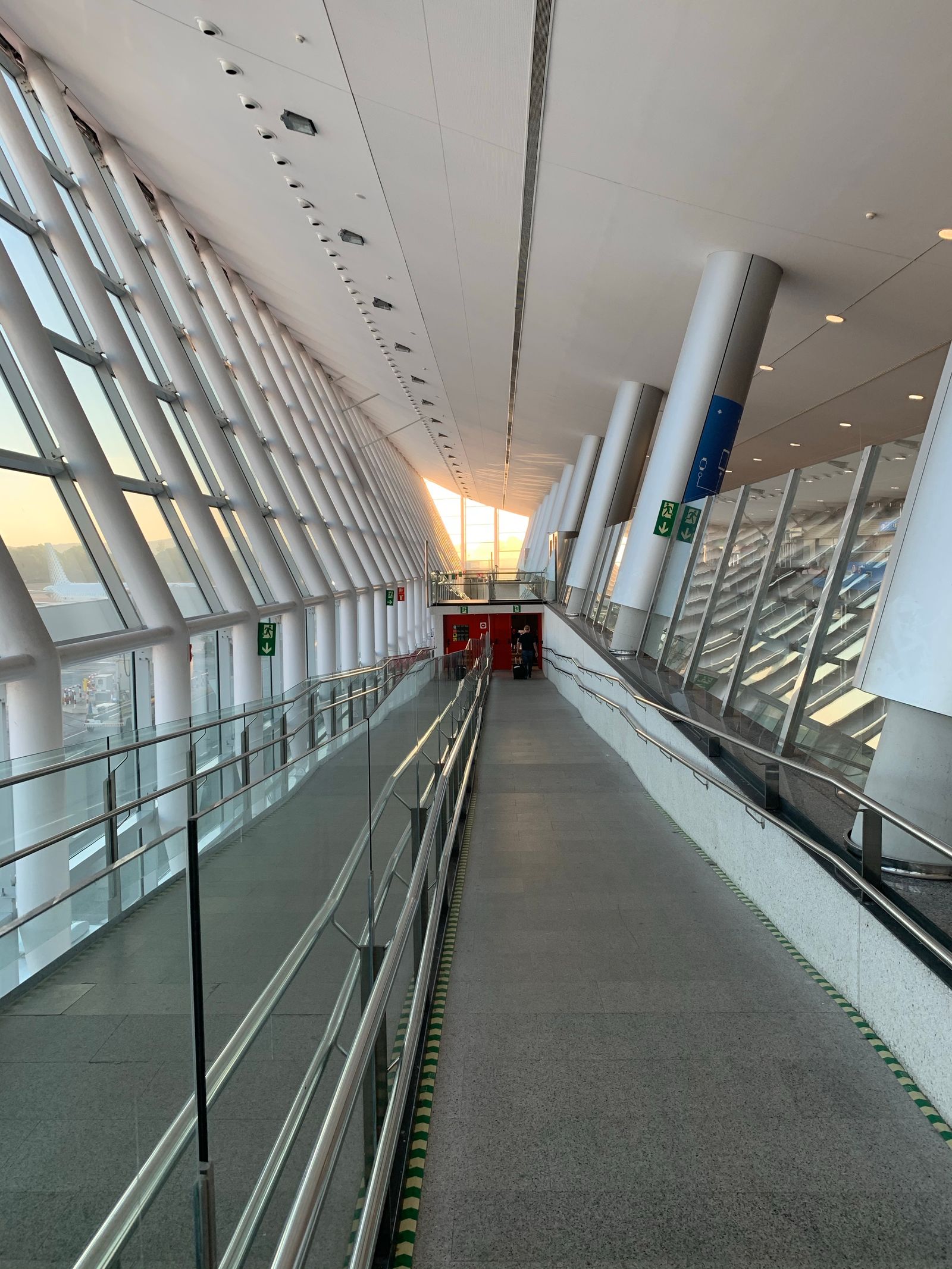 Empty airport terminal seating area near gates