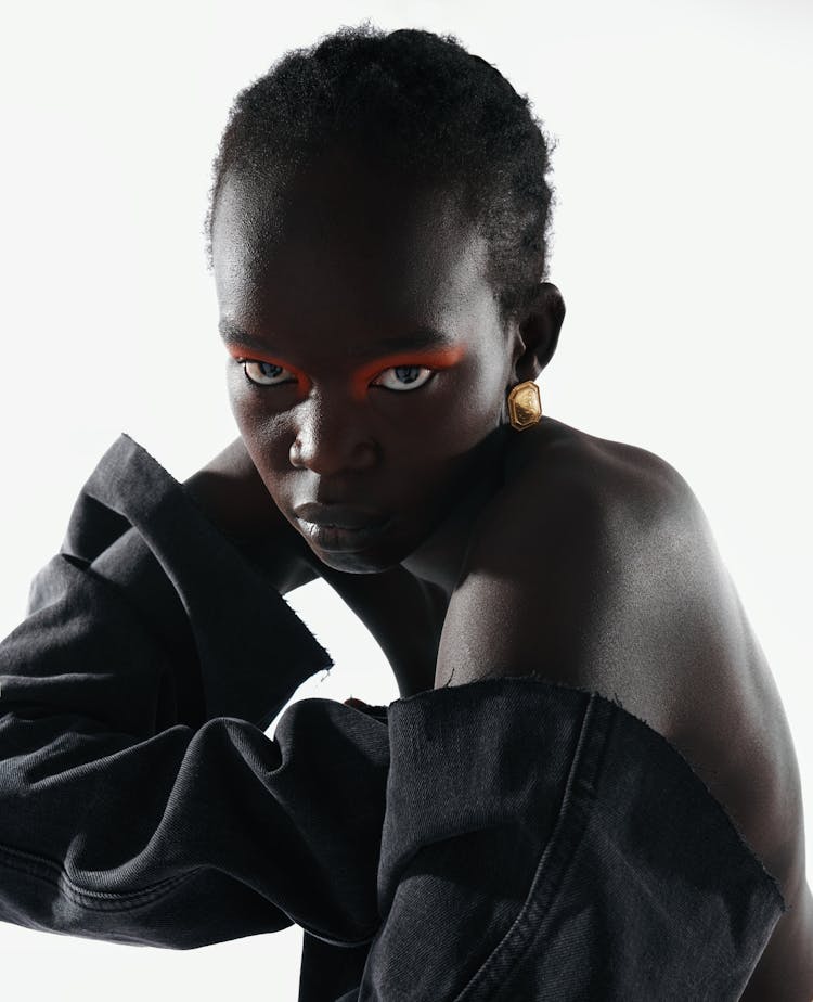 Portrait Of Woman Wearing Red Eyeshadow On White Background