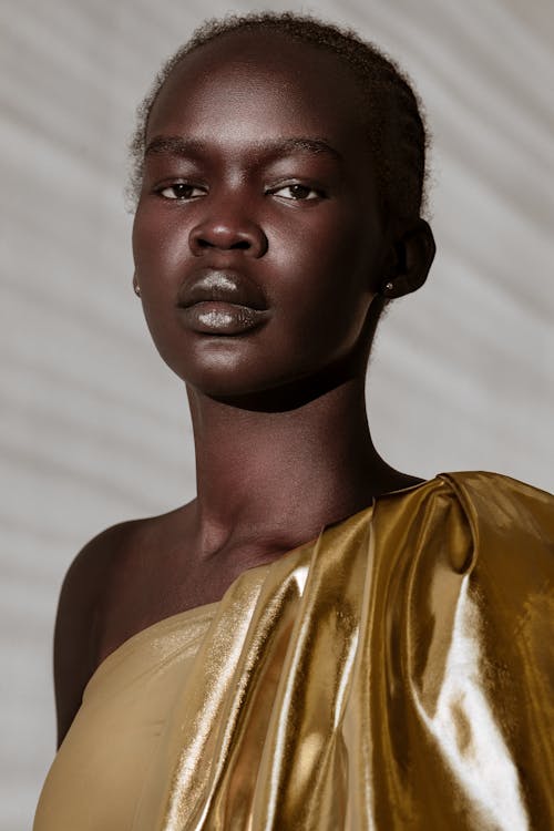 Young Woman Wearing Clothing in Gold Colour