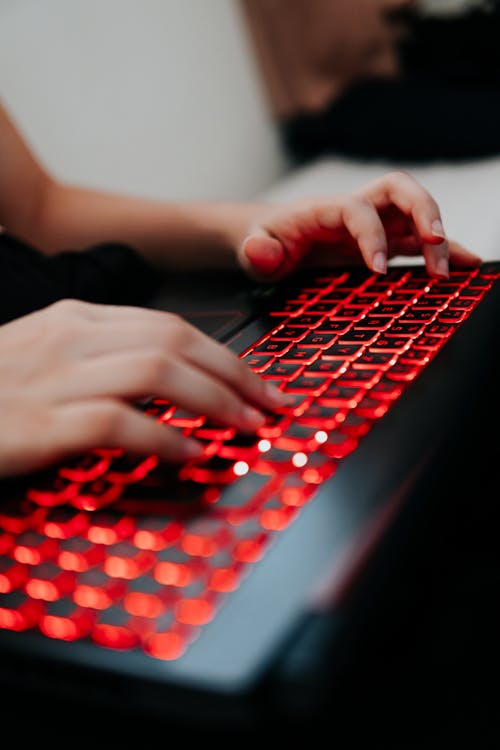 Photo of a Person Typing on Computer Keyboard