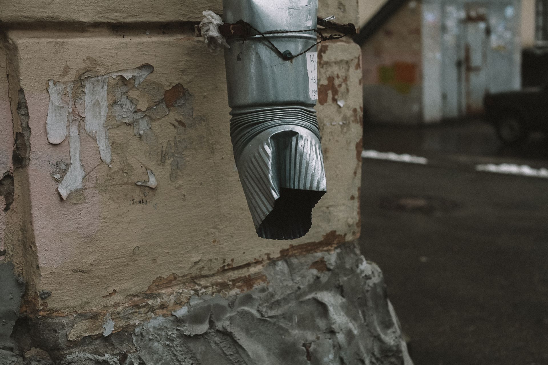 A Silver Metal Pipe on Brown Concrete Wall