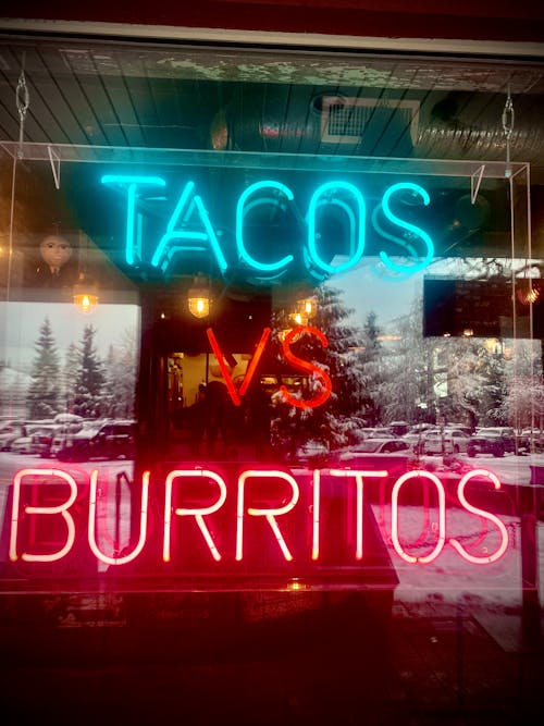 Red and Blue Neon Light Signages on Glass Panel