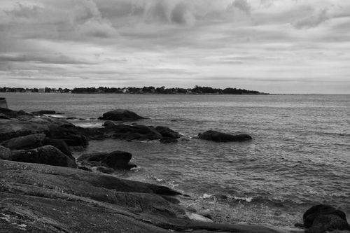 Free Dramatic seascape with rocky shorelines under an overcast sky in monochrome. Stock Photo