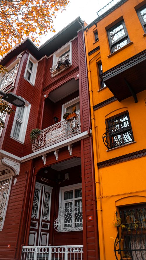 Free Vivid urban architecture showcasing bright red and orange building facades in autumn. Stock Photo