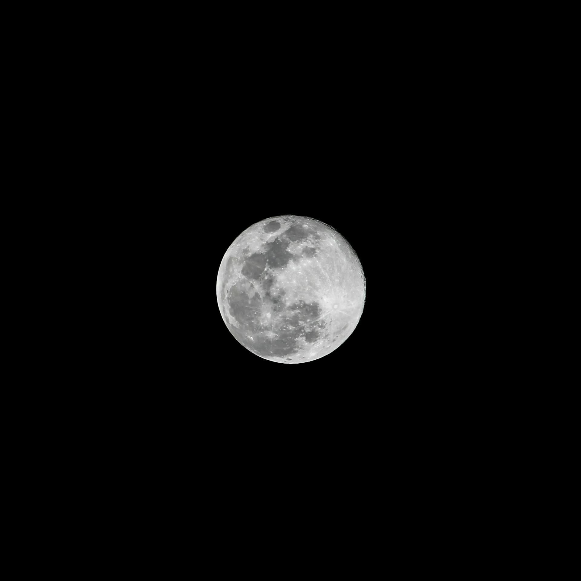 Captivating full moon in a dark night sky, showcasing lunar details with clarity.