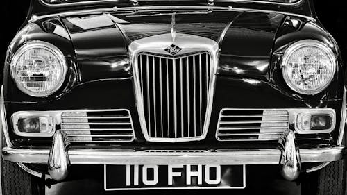 Grayscale Photo of a Vintage Car