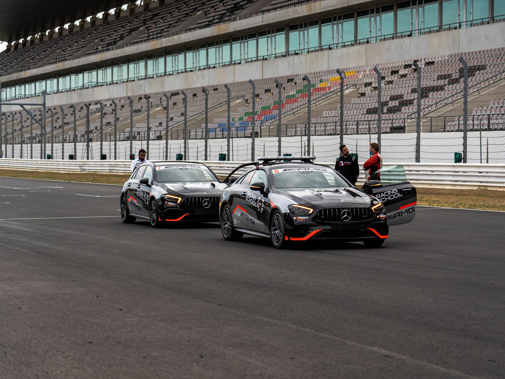 Two Mercedes AMG cars on the Portimão race track, showcasing luxury and performance.