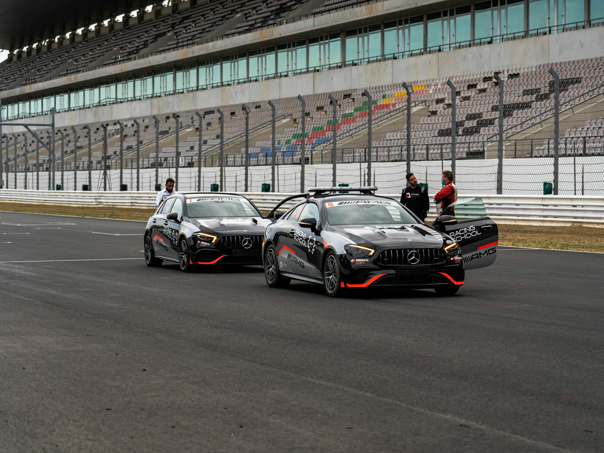 Black Cars Parked on Asphalt Road in a Racing Track · Free Stock Photo