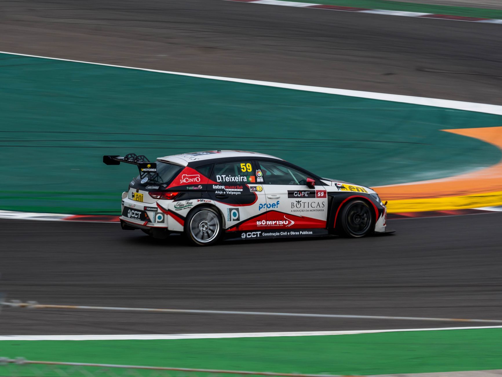 Dynamic shot of a race car speeding on Portimão Circuit, Portugal, capturing the thrill of motorsport.