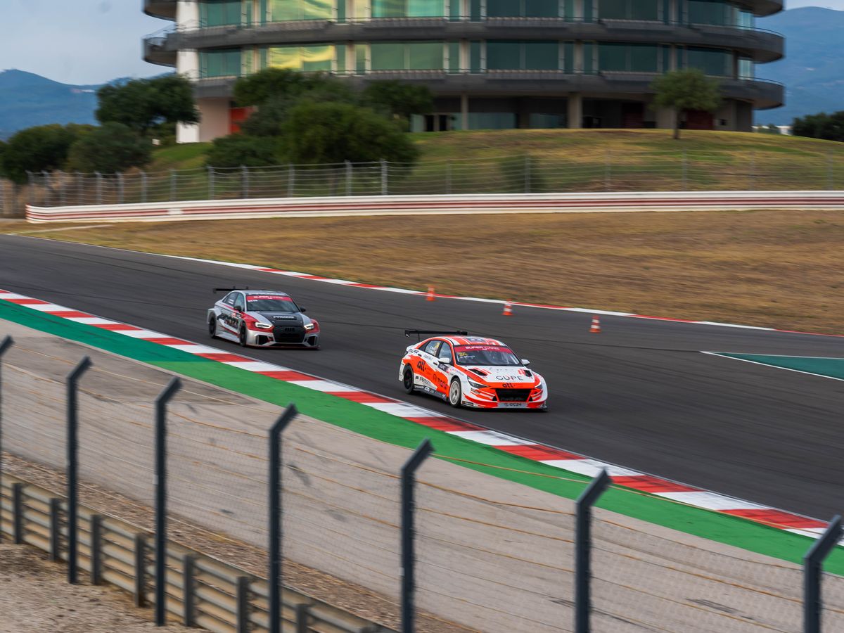 Entry-level touring cars racing on a track