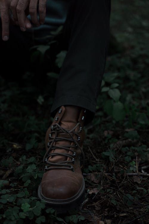 Leather boot of Man Sitting in Forest