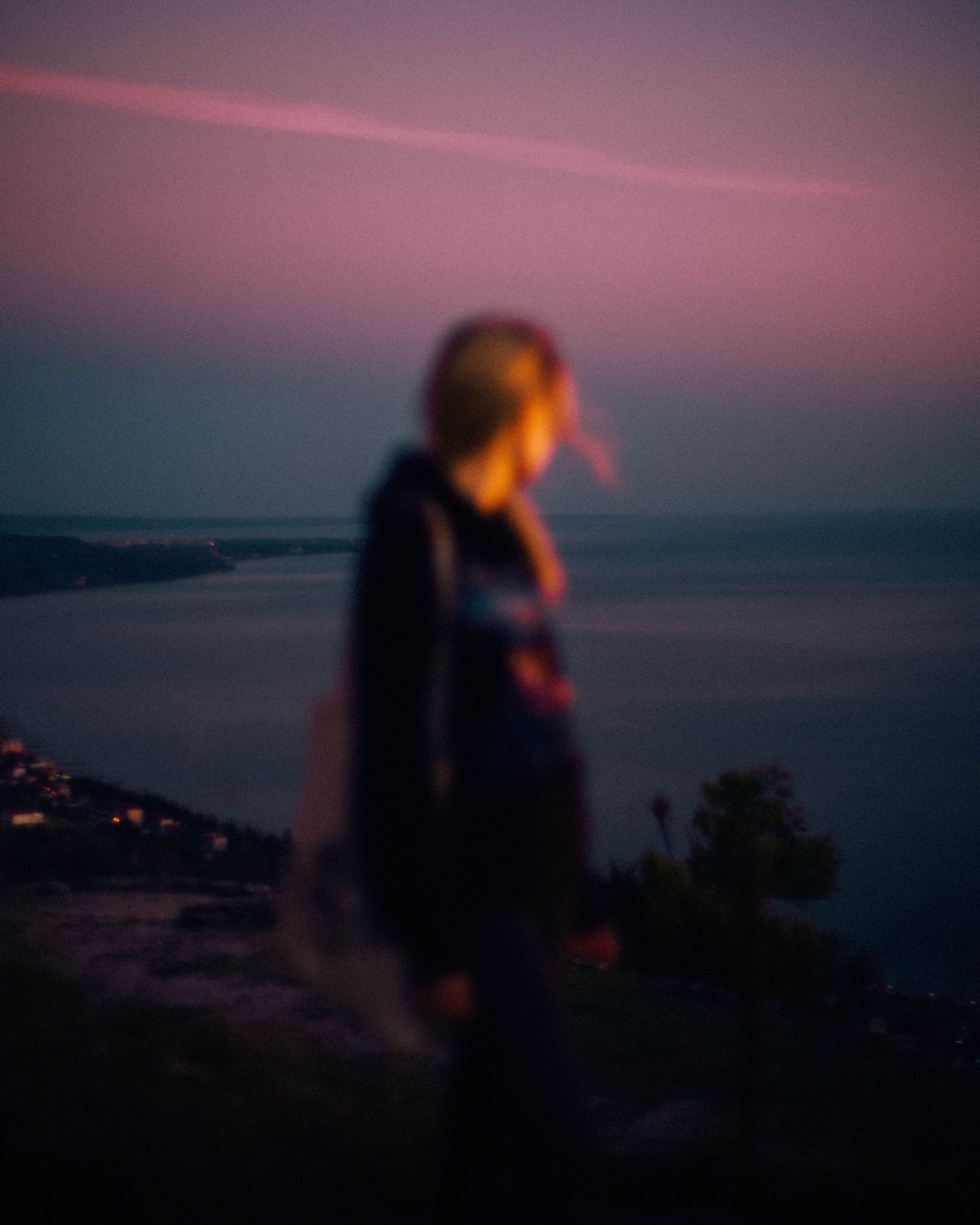 Woman Standing Near Body of Water during Sunset · Free Stock Photo