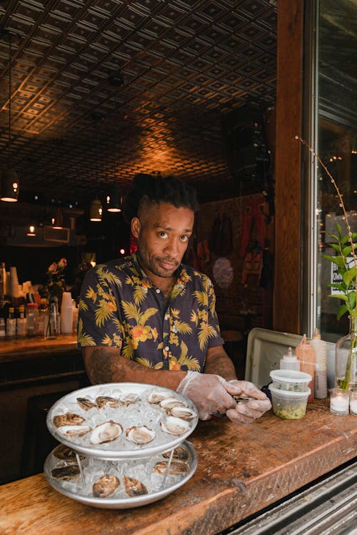 Portrait of Man Preparing Fresh Oysters in Restaurant
