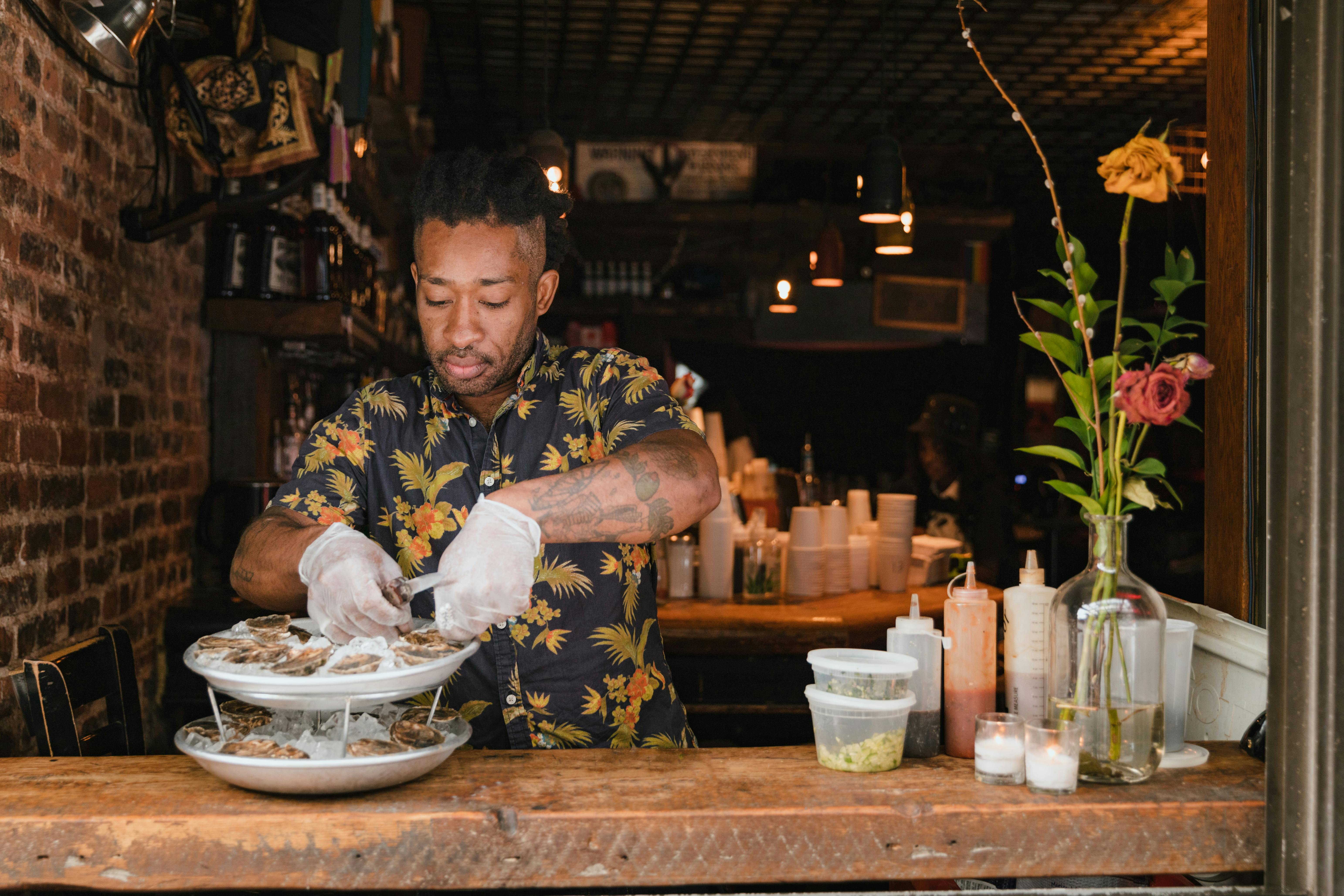 chef shucking oysters - seafood catering for weddings