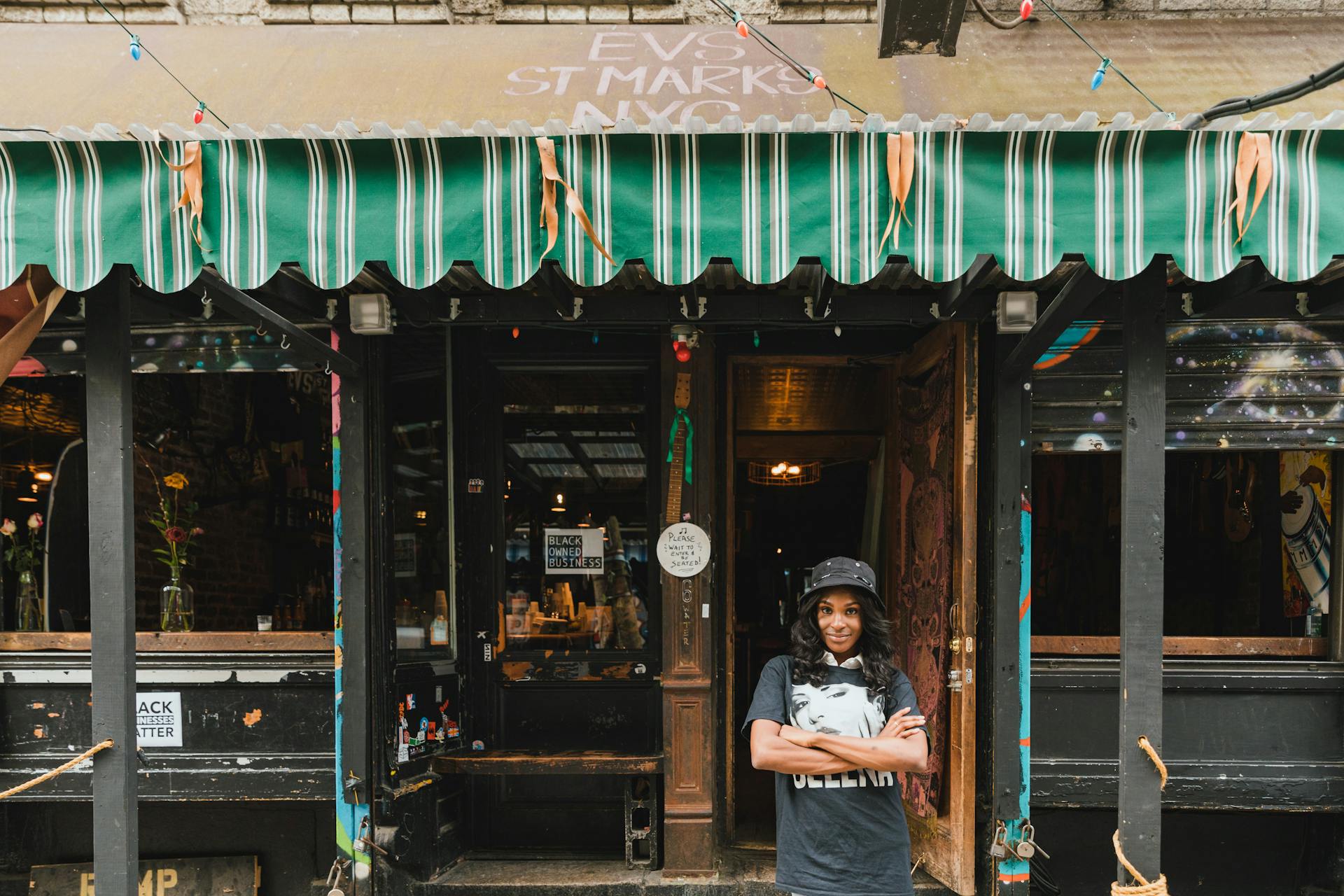 Portrait of Smiling Female Owner in Front of Cafe