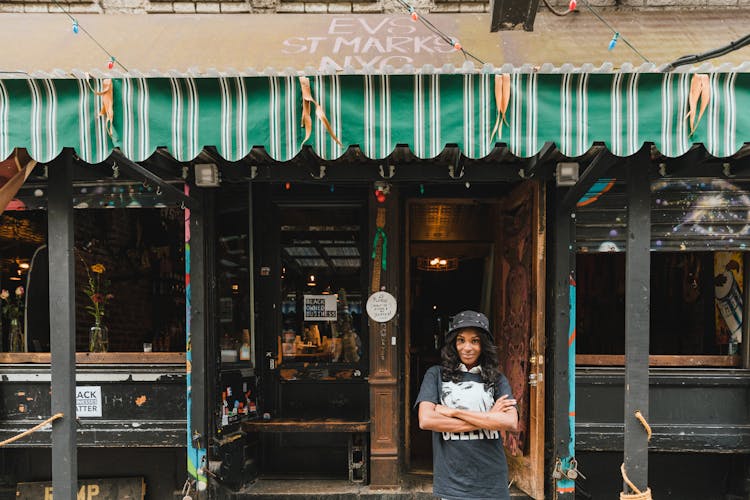 Portrait Of Smiling Female Owner In Front Of Cafe