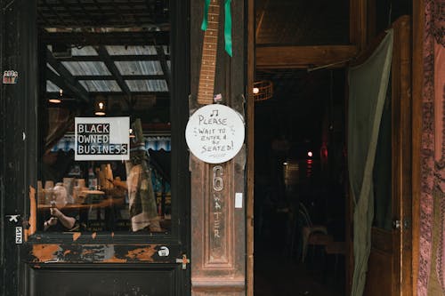 Entrance of Cafe with Black Owned Business Sign