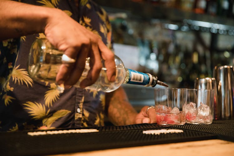 Man Pouring Drink At Bar Counter