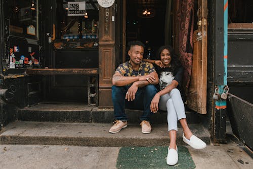 Portrait of Smiling Owners in Front of Cafe