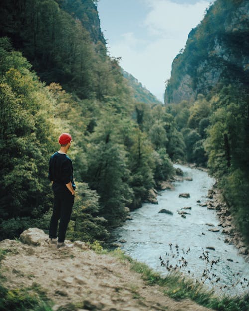 Man Looking on a River in a Canyon