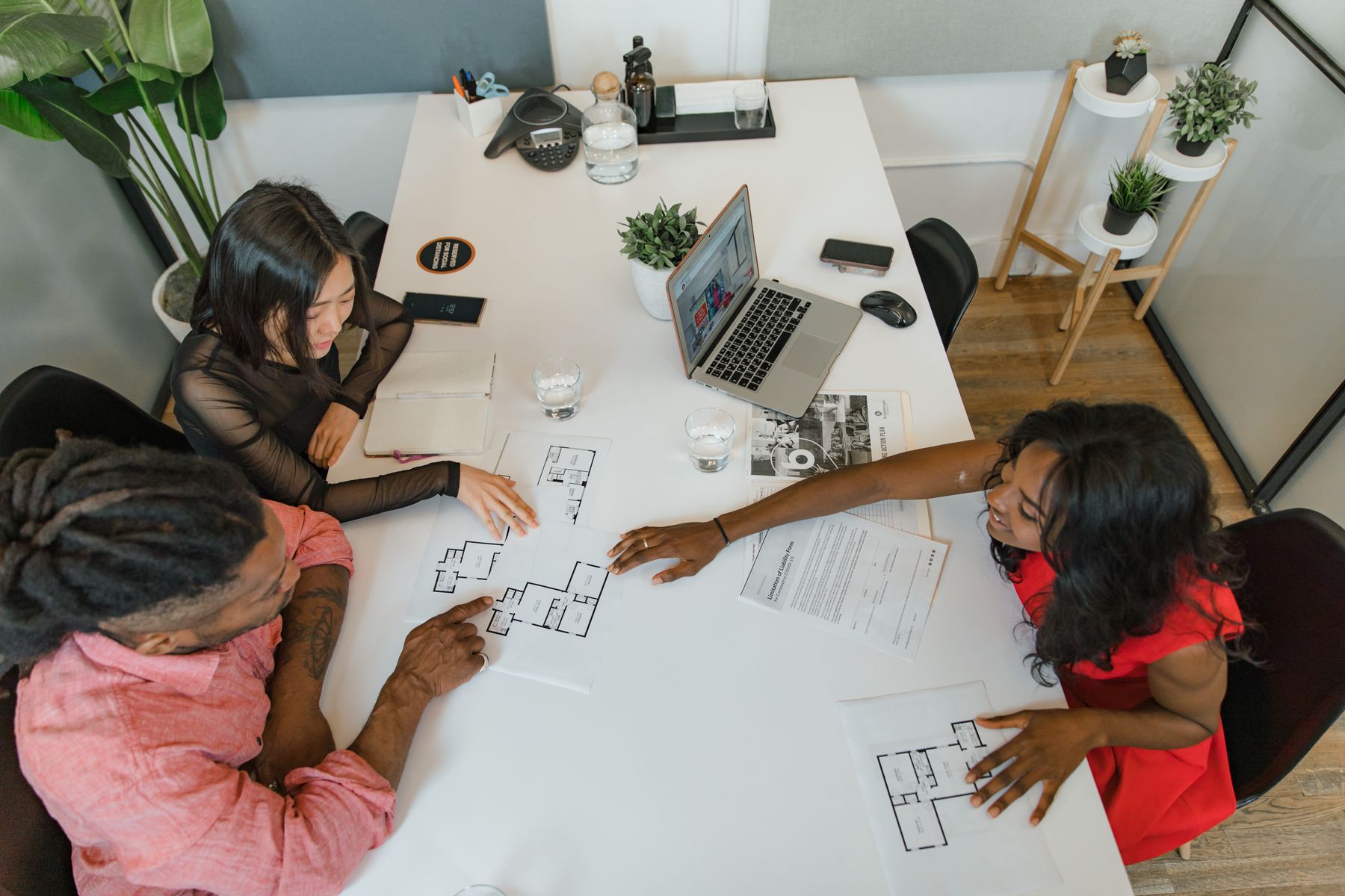 Creative team reviewing floor plans together