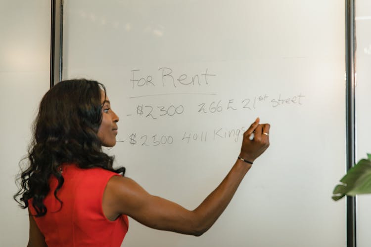 Woman Writing On A Whiteboard