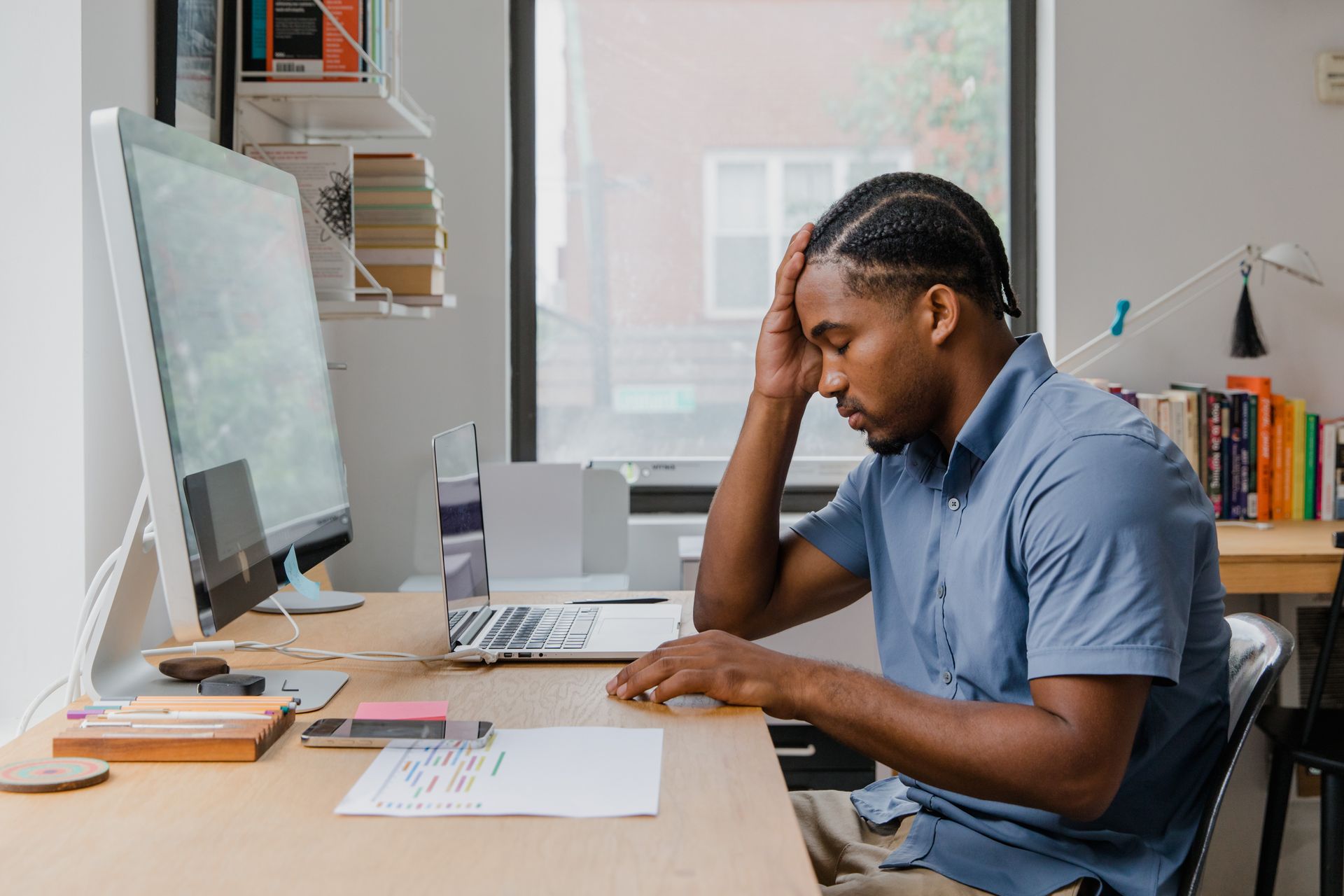 Man working at desk with computers in office