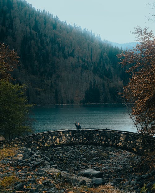 Free Person on Concrete Bridge Near the Lake Stock Photo