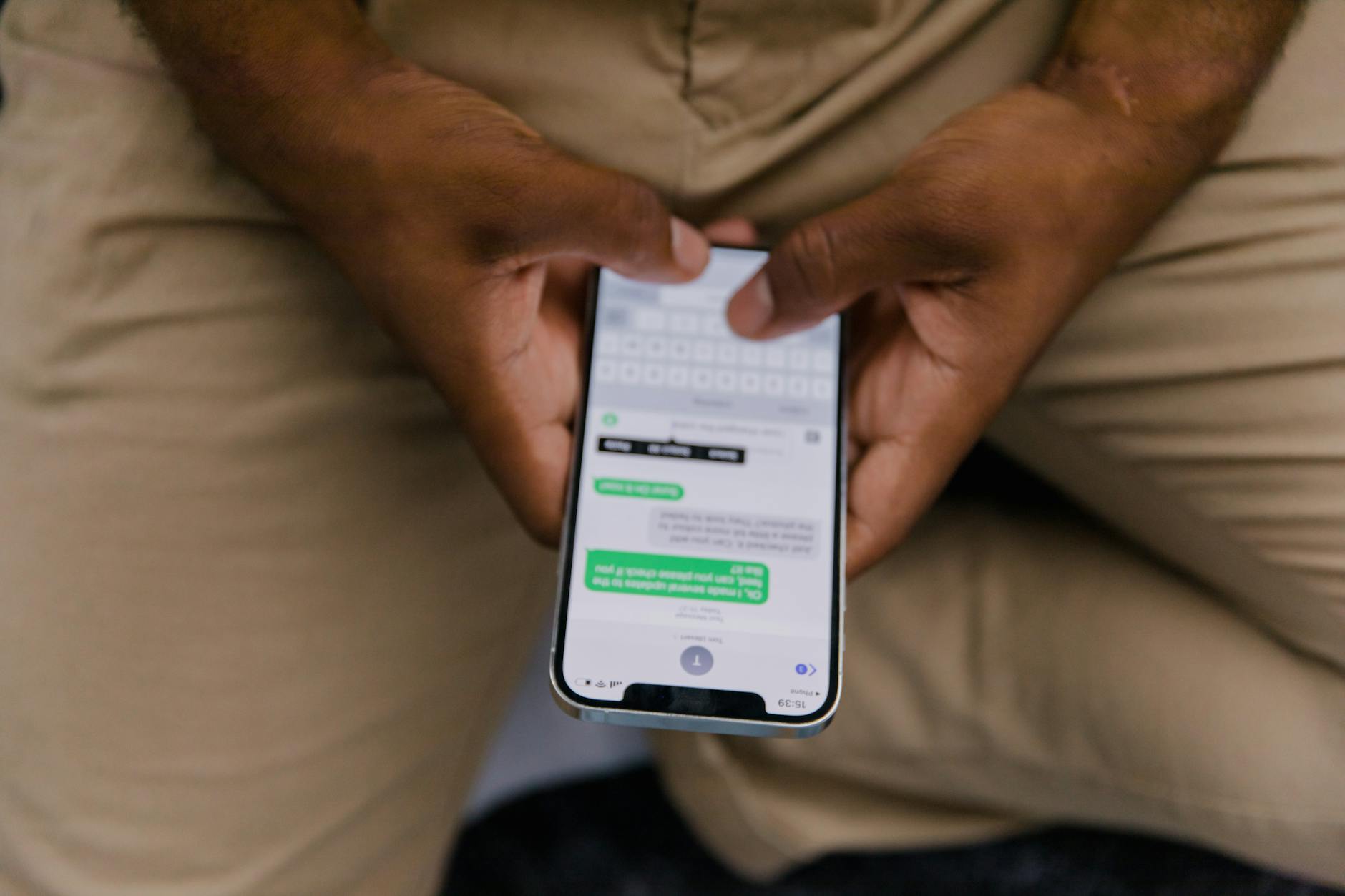 Close-Up View of Man Texting on Phone