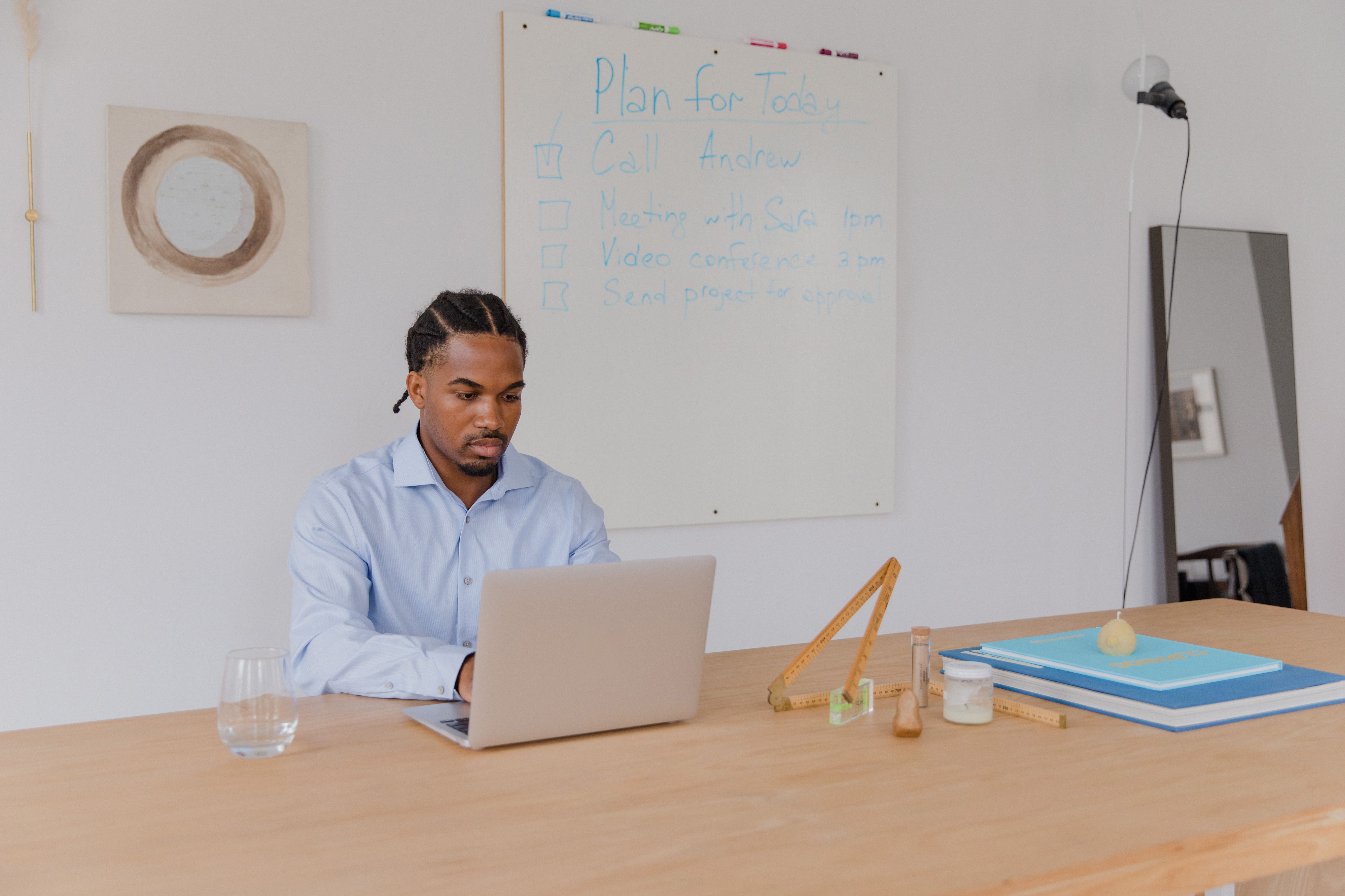 Adult with ADHD working at desk with organizational tools - adhd therapy sacramento
