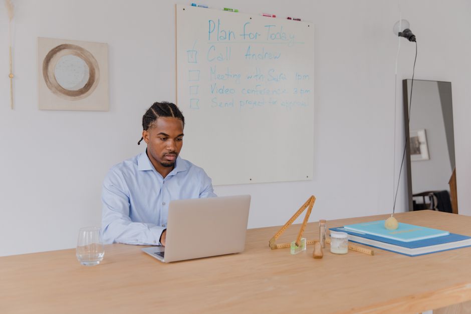 Adult with ADHD working at desk with organizational tools - adhd therapy sacramento