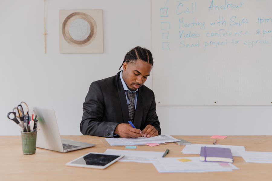 Professional man reviewing documents at his office desk with attention to detail.