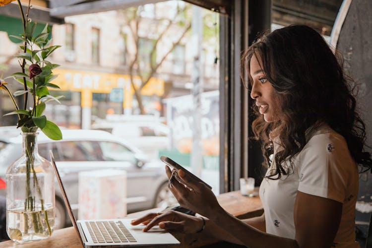 Businesswoman Working On Laptop In Cafe